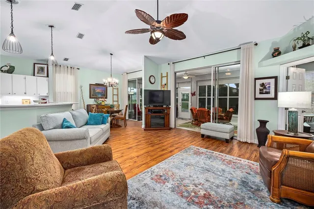 a living room with furniture kitchen view a flat screen tv
