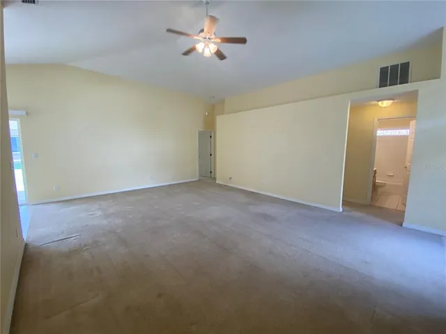 a view of empty room with a ceiling fan