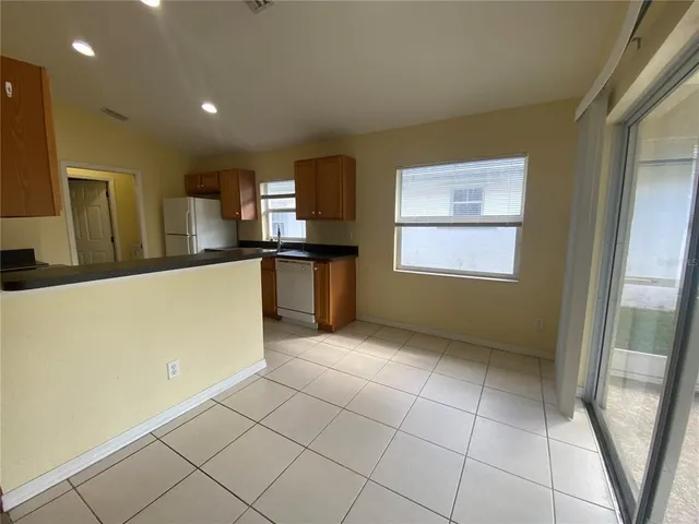 a kitchen with stainless steel appliances a refrigerator sink and microwave