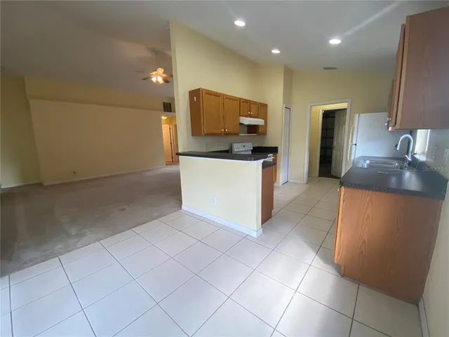 a kitchen with stainless steel appliances a refrigerator sink and microwave