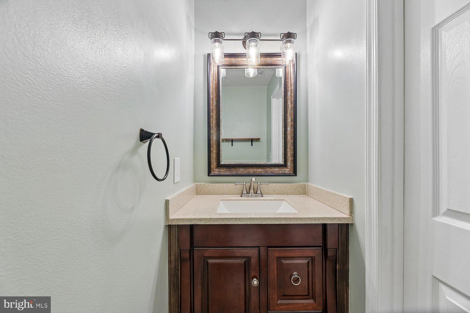 15764 Beau Ridge Drive Woodbridge, VA 22193 - Photo 17 of 58 a bathroom with a sink and a mirror