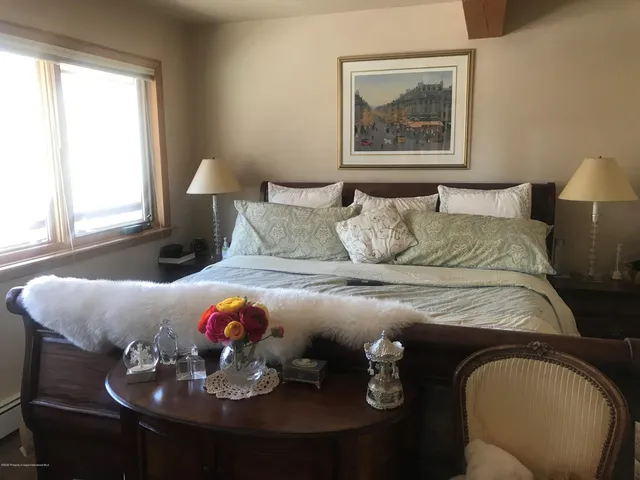 a bedroom with a bed and dresser