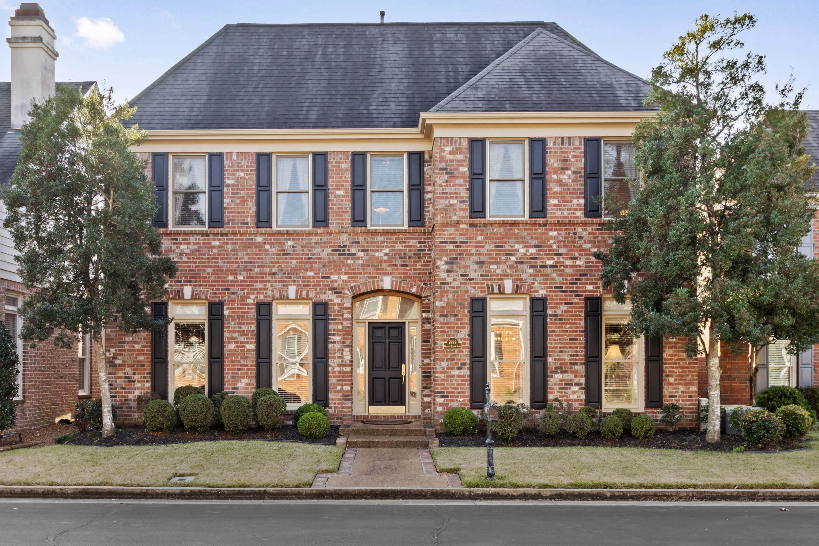 7999 Willow Brook Road Germantown, TN 38138 - Photo 1 of 29 Colonial home with a front lawn, a shingled roof, and brick siding