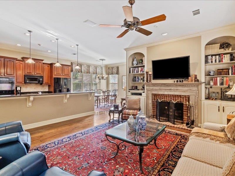 7999 Willow Brook Road Germantown, TN 38138 - Photo 10 of 29 Gas fireplace with flanking bookshelves adjoining breakfast area