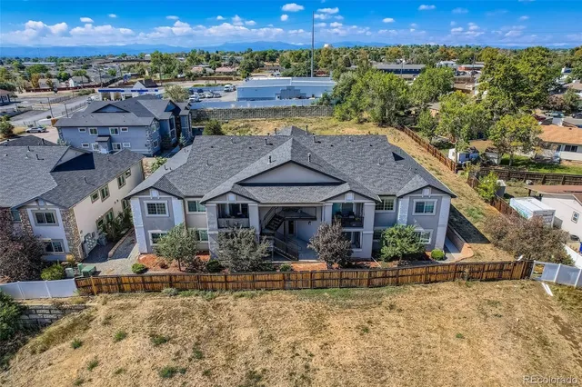 a aerial view of a house with a yard and pool
