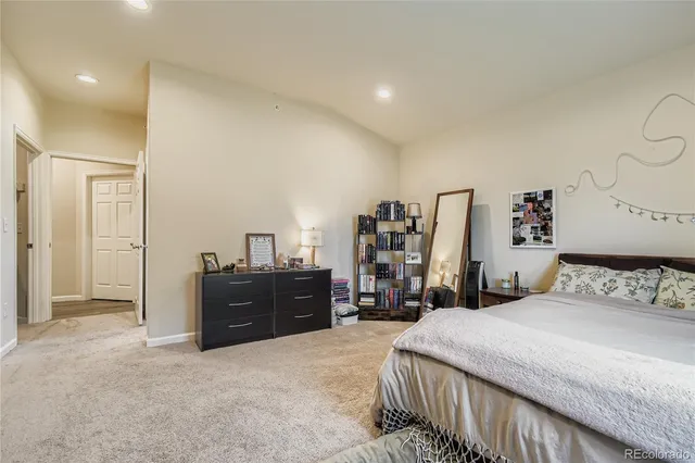 a bedroom with a bed and cabinets