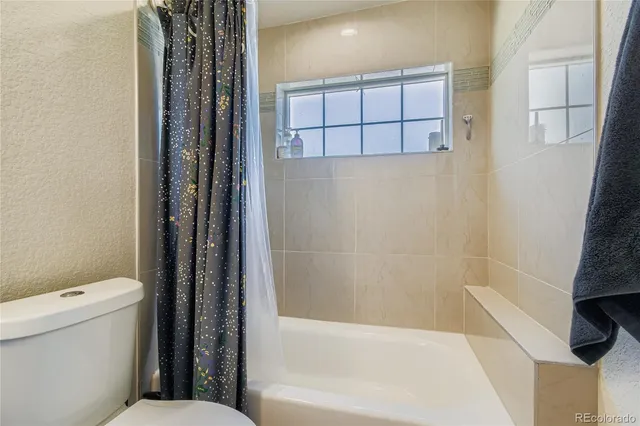 a bathroom with a bathtub and a toilet