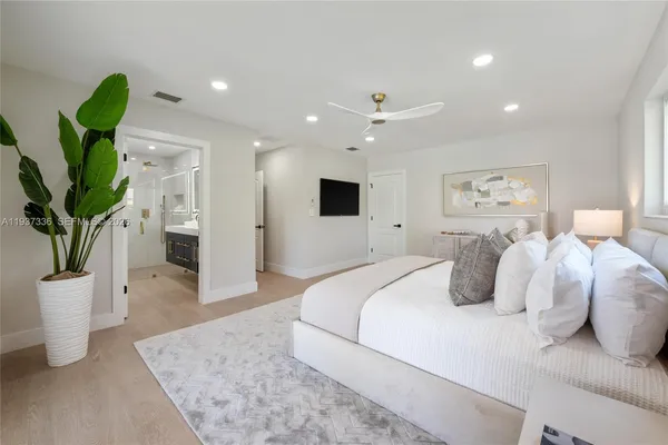 a spacious bedroom with a large bed and a window