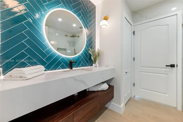 a bathroom with a sink and a mirror