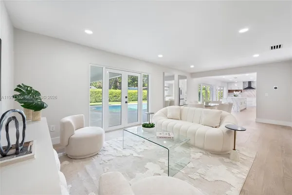 a kitchen with white cabinets and refrigerator