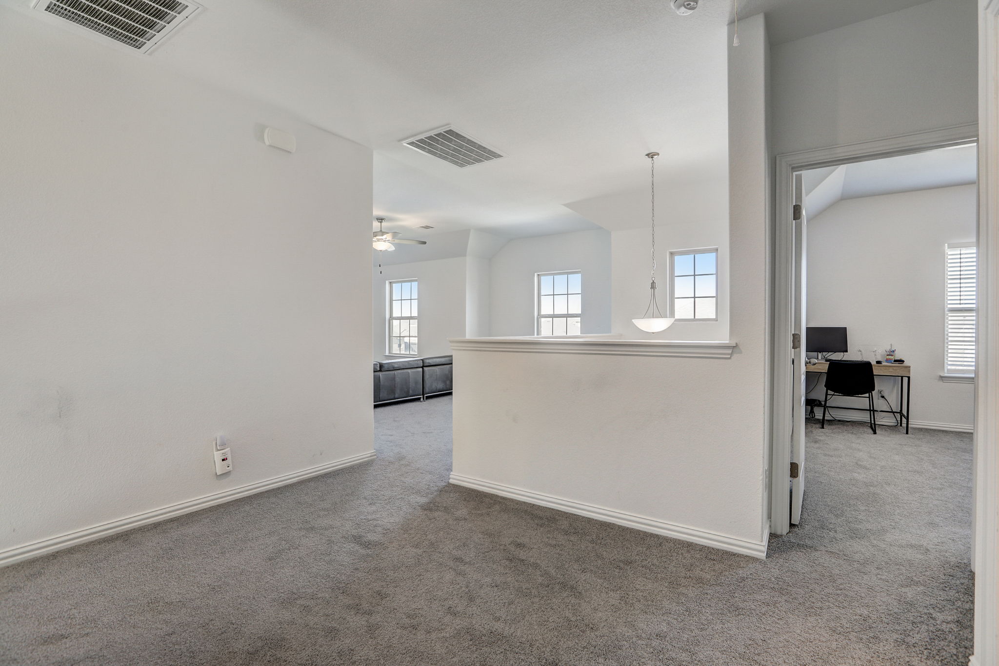 308 Monteforte Road Hutto, TX 78634 - Photo 17 of 32 an empty room with kitchen view and wooden floor