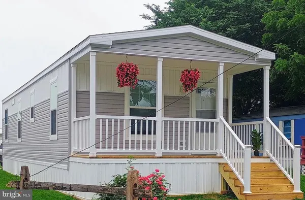 a view of house with a balcony and furniture