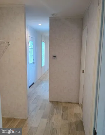 a view of a hallway with wooden floor