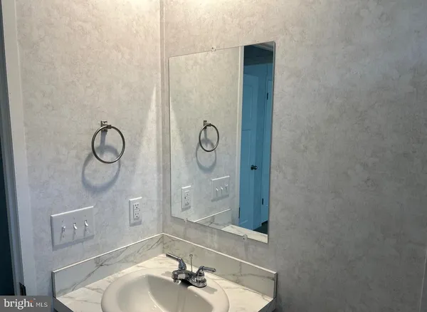 a bathroom with mirror a sink and vanity