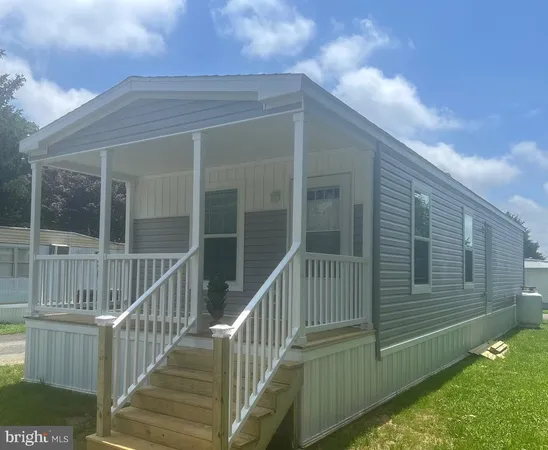 a view of a house with a small deck
