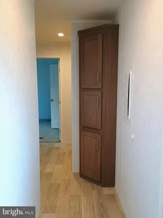 a view of hallway with wooden floor
