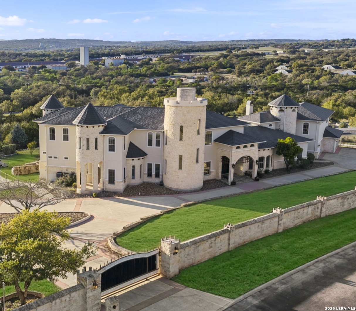 an aerial view of a house with a garden and lake view