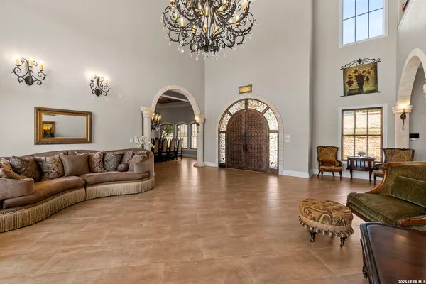 a large kitchen with a large counter top space a sink stainless steel appliances and cabinets