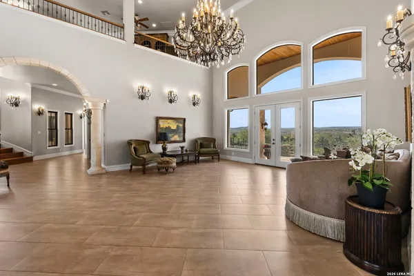 a dining room with furniture a chandelier and wooden floor