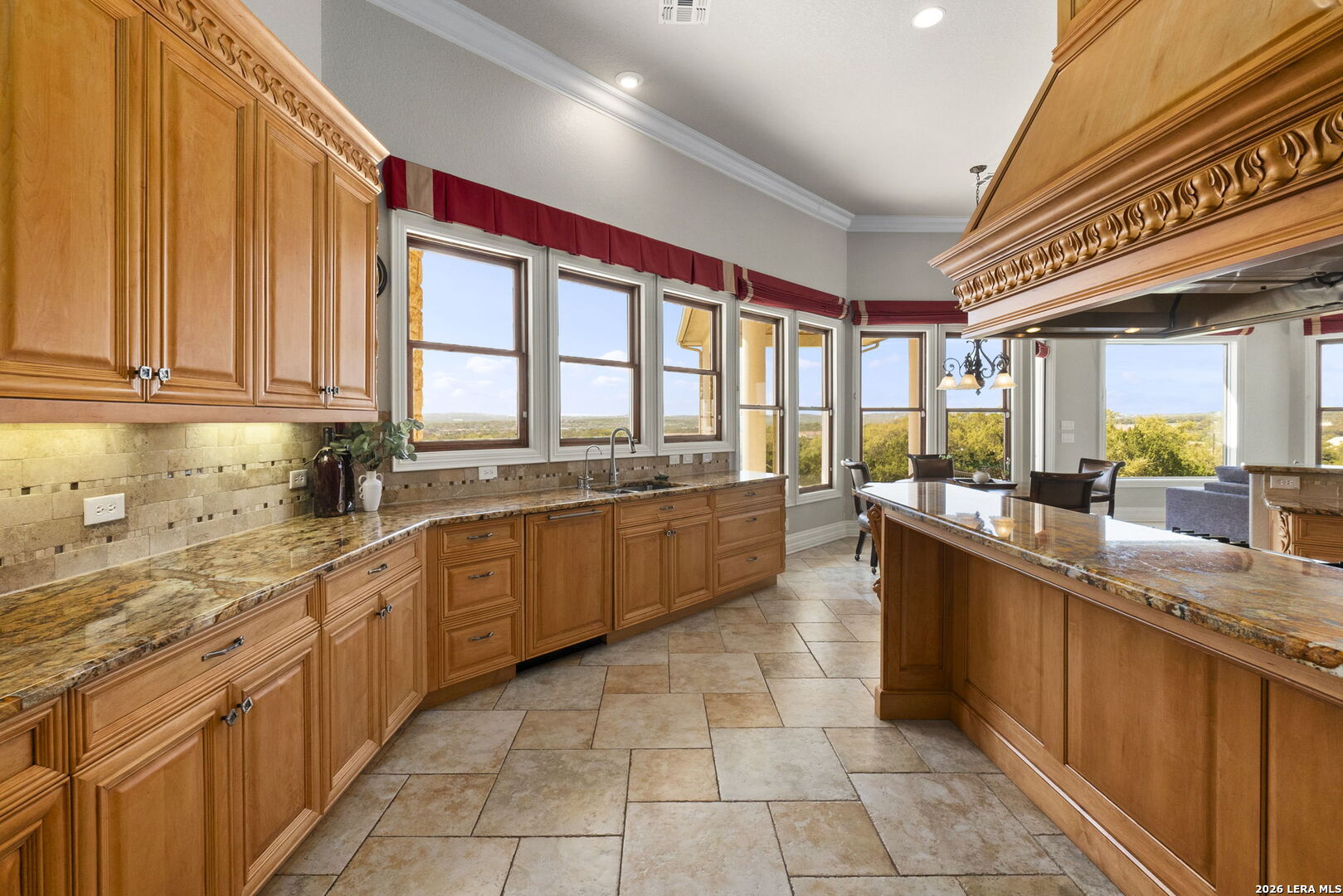 6762 Mnr Hl Road San Antonio, TX 78257 - Photo 15 of 51 a large kitchen with a large counter top space a sink stainless steel appliances and cabinets