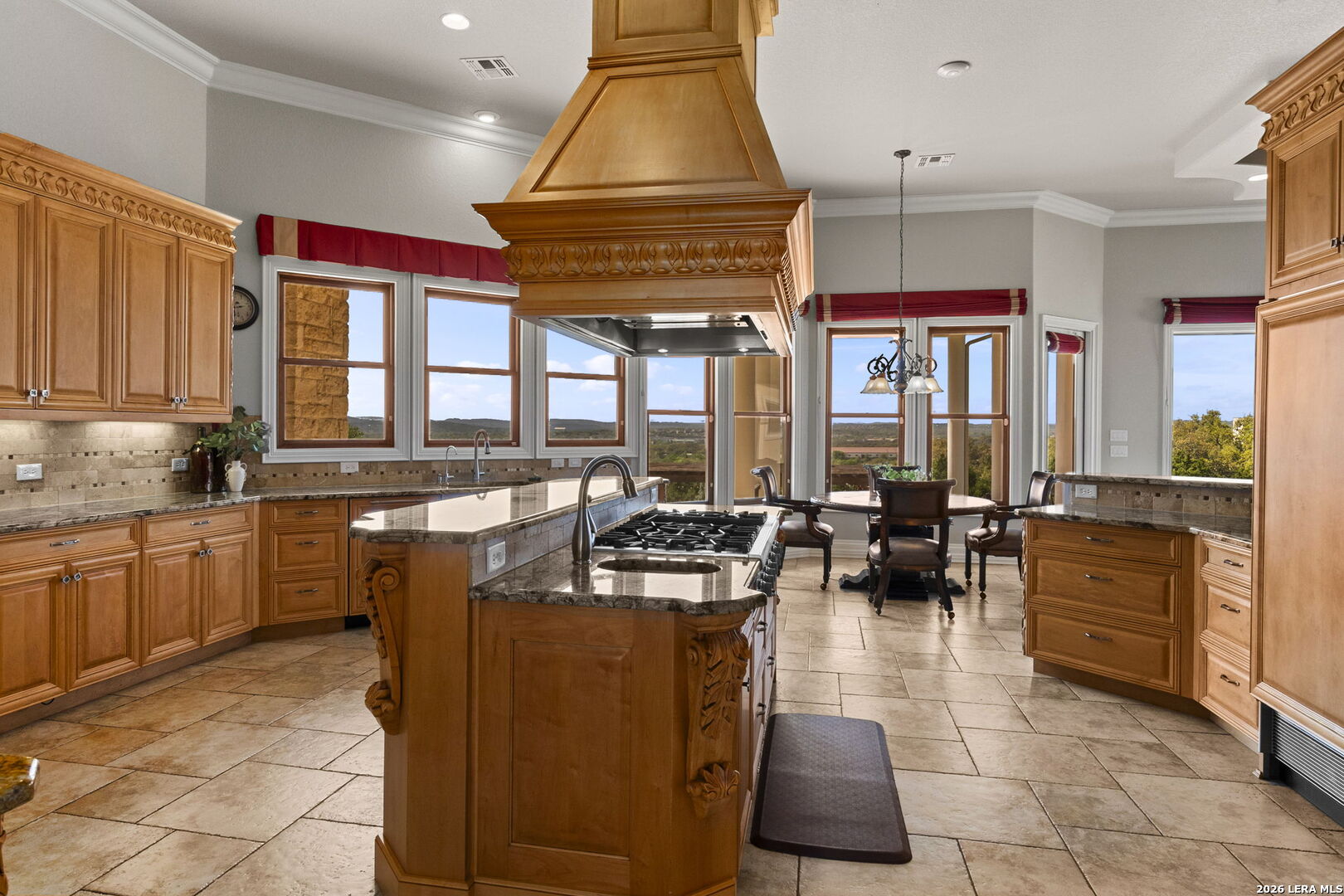 6762 Mnr Hl Road San Antonio, TX 78257 - Photo 17 of 51 a kitchen with stainless steel appliances granite countertop a stove a sink and a microwave