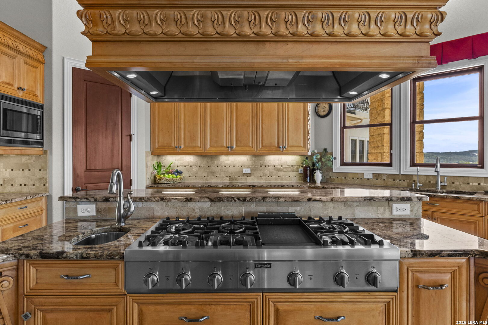 6762 Mnr Hl Road San Antonio, TX 78257 - Photo 18 of 51 a kitchen with a stove a sink and a counter top space