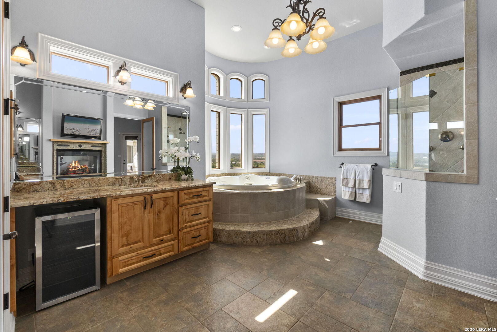 6762 Mnr Hl Road San Antonio, TX 78257 - Photo 26 of 51 a large spacious bathroom with a granite countertop sink a large mirror and a bathtub