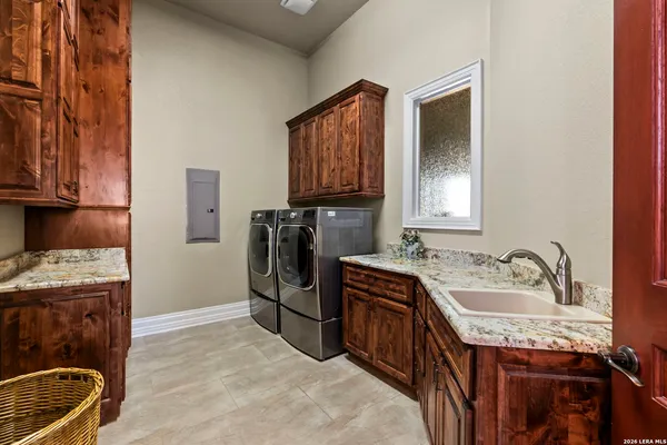 a bedroom with a bed and large windows