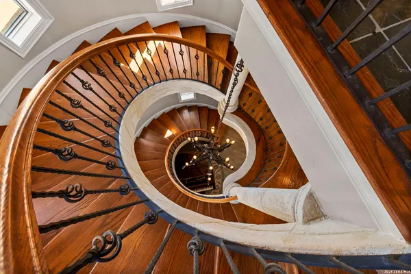 a spacious bedroom with a bed and a chandelier