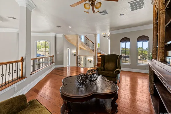 a spacious bedroom with a bed and a chandelier
