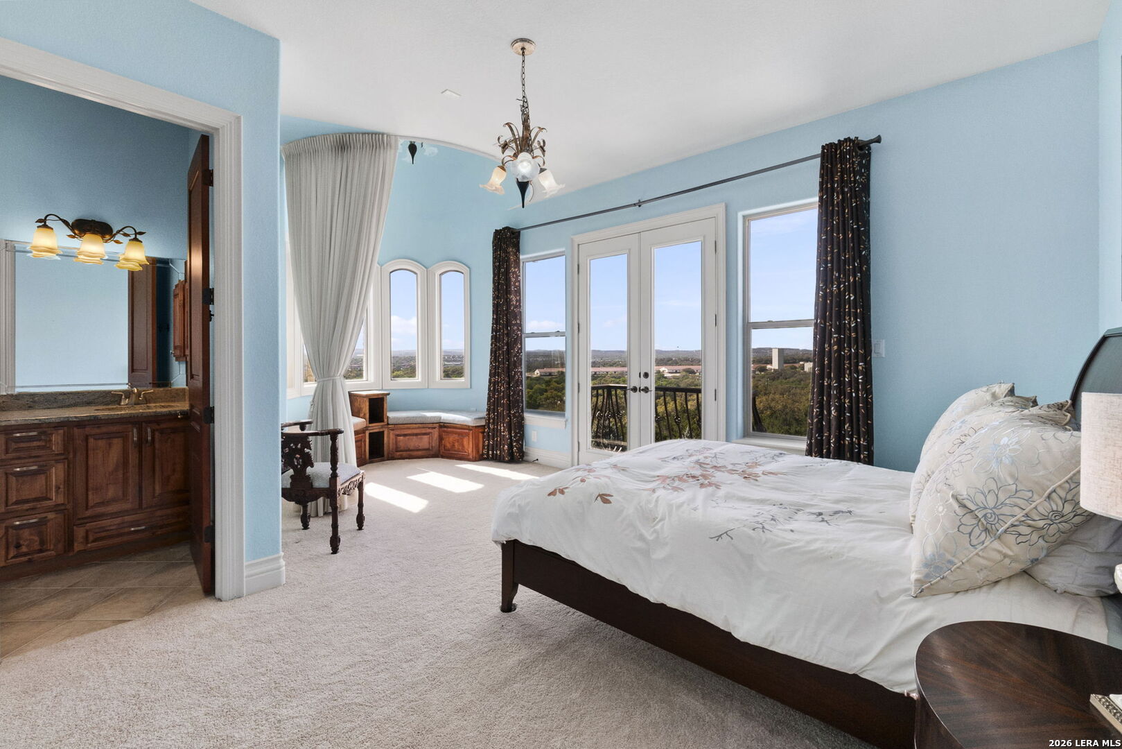 6762 Mnr Hl Road San Antonio, TX 78257 - Photo 34 of 51 a bedroom with a bed and large windows