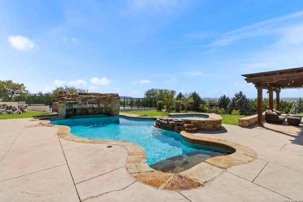 a view of a swimming pool with lounge chair