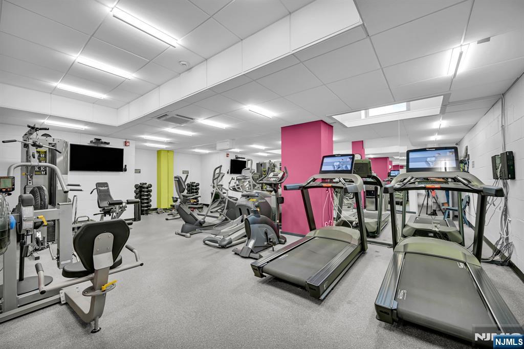 280 Prospect Avenue, Unit 3N Hackensack, NJ 07601 - Photo 21 of 23 a room with gym equipment and a flat screen tv