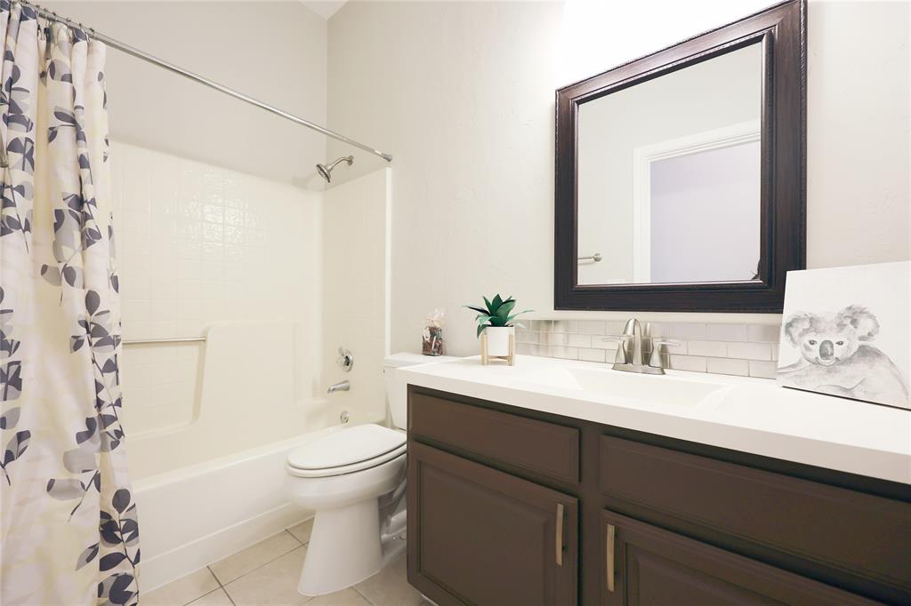 8112 Dock Street Frisco, TX 75035 - Photo 26 of 34 a bathroom with a sink a toilet and shower