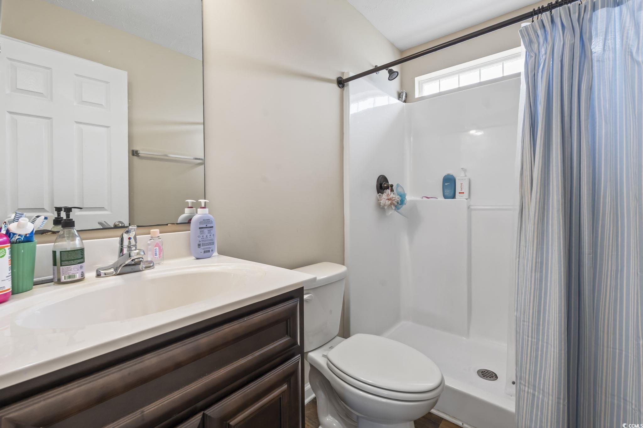 282 Foxpath Loop Myrtle Beach, SC 29588 - Photo 22 of 34 Bathroom with toilet, vanity, and curtained shower
