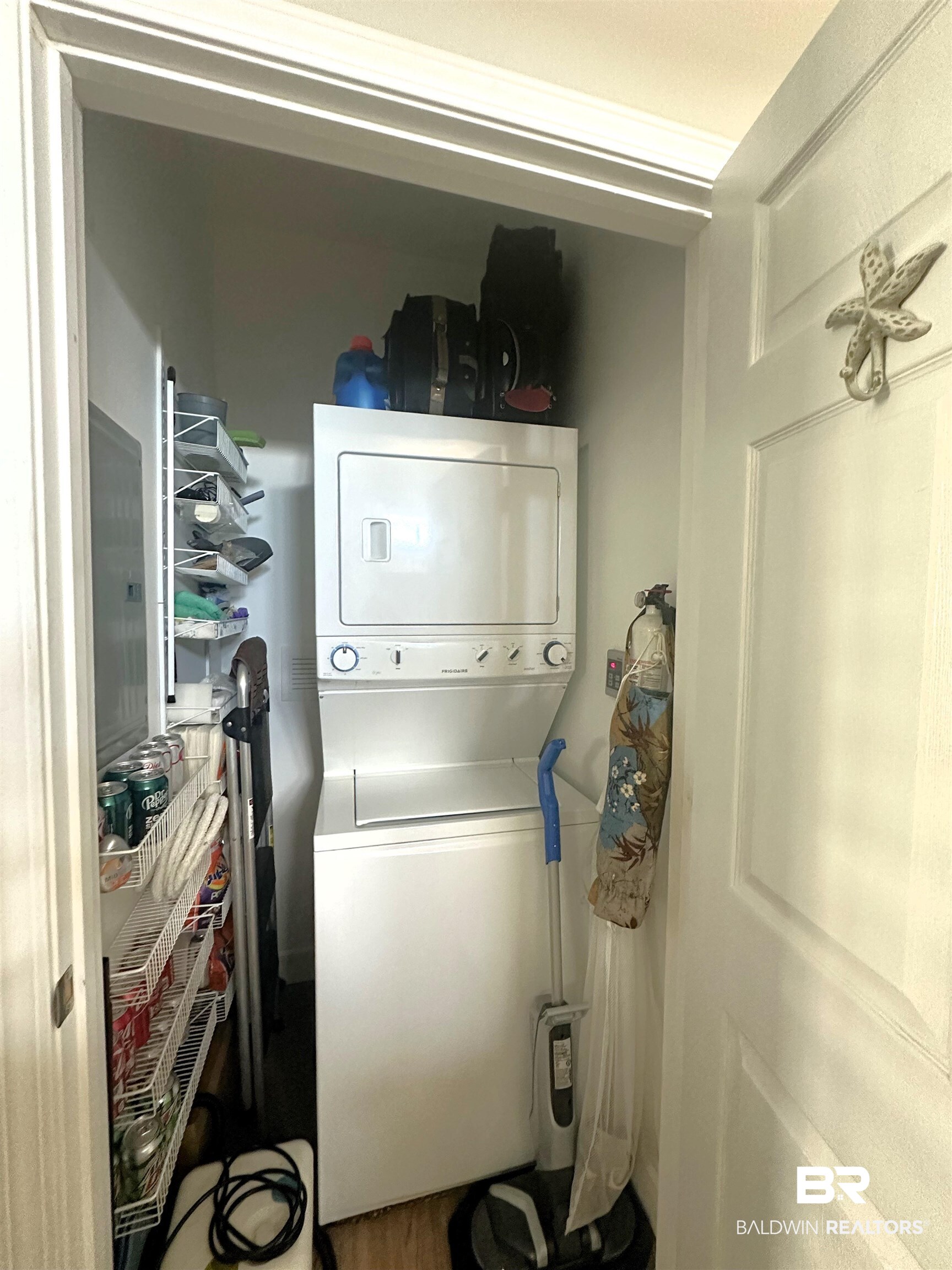 Laundry area with stacked washing maching and dryer