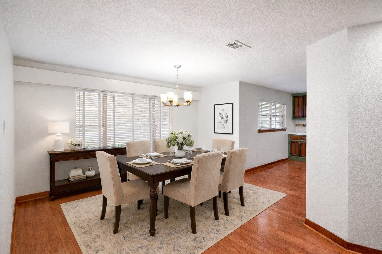 405 Hohldale Street Houston, TX 77091 - Photo 14 of 39 This virtually staged picture of the dining room highlights a potential furniture arrangement that creates a warm, welcoming atmosphere ideal for hosting gatherings.