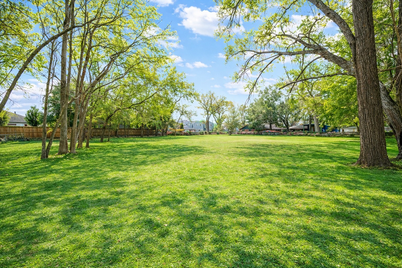 405 Hohldale Street Houston, TX 77091 - Photo 2 of 39 Spacious yard spanning nearly two acres with mature trees, ideal for outdoor use.
