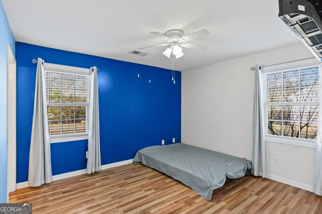 a bedroom with a bed dresser and a window