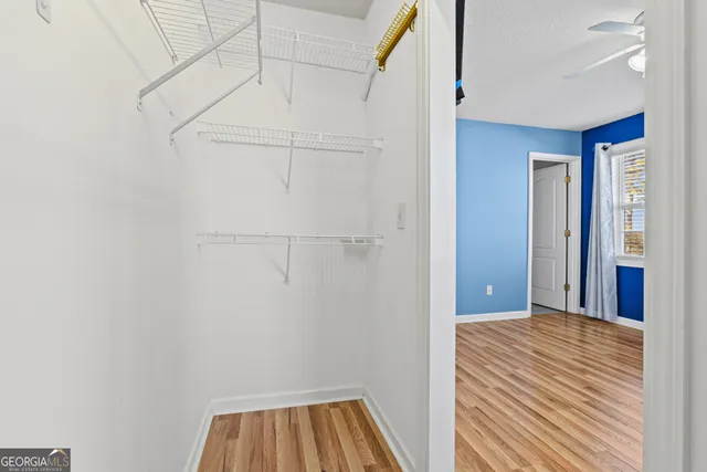 a view of a room with wooden floor