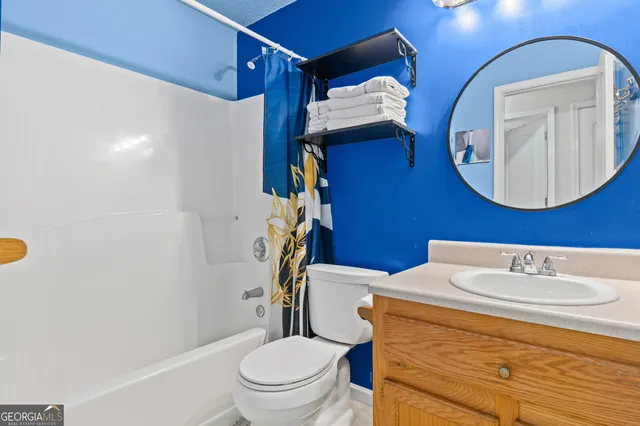a bathroom with a sink a toilet and mirror