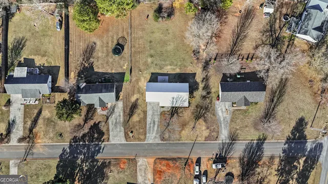 an aerial view of a house with a tree