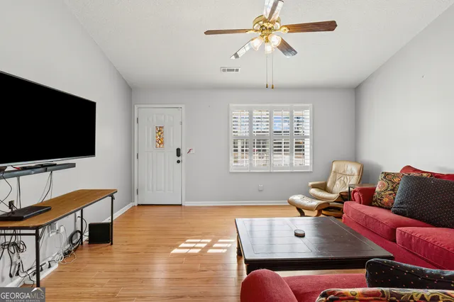 a living room with furniture and a flat screen tv