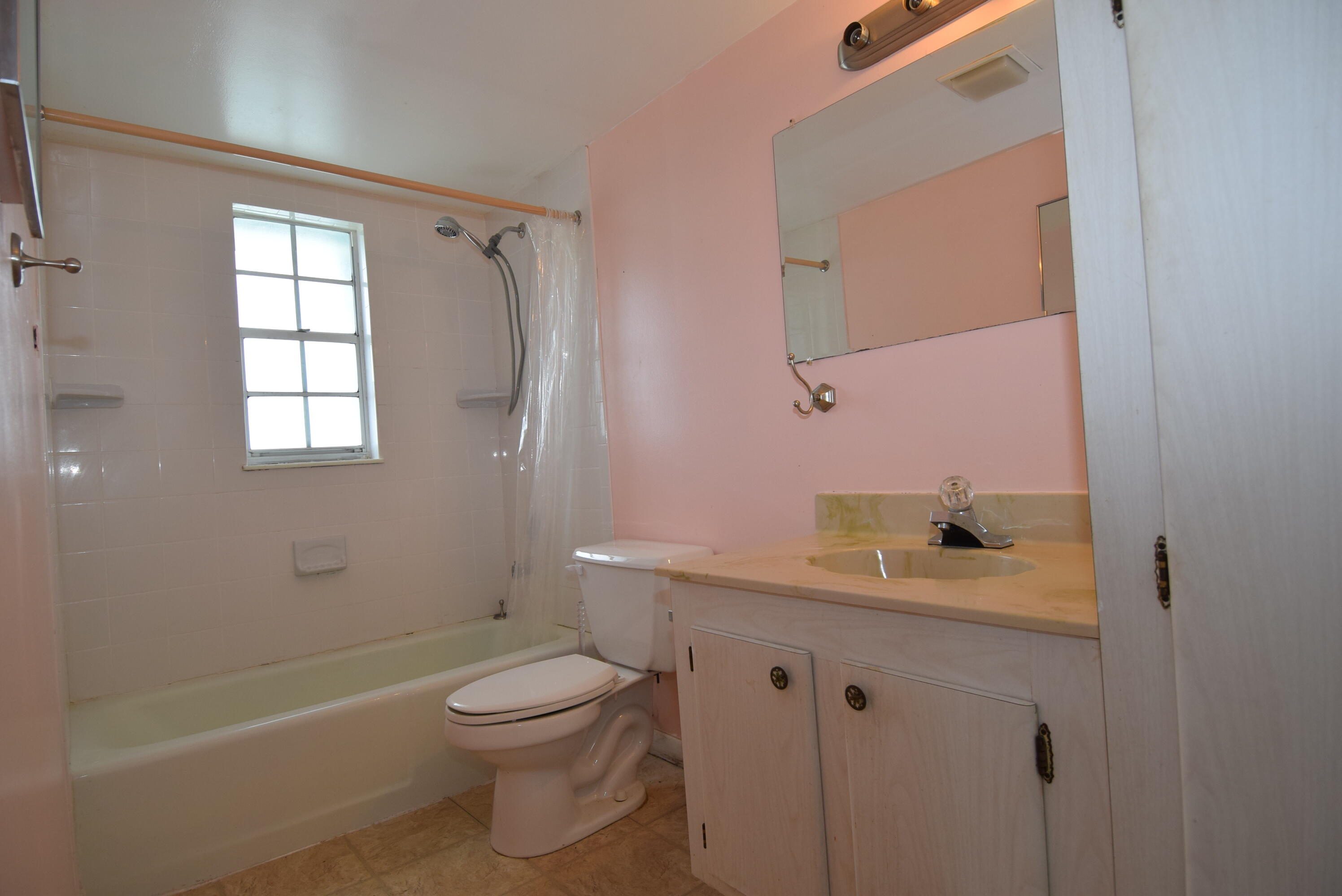 40 High Point Road, Unit F201 Tavernier, FL 33070 - Photo 9 of 11 a bathroom with a granite countertop toilet a sink and a bathtub