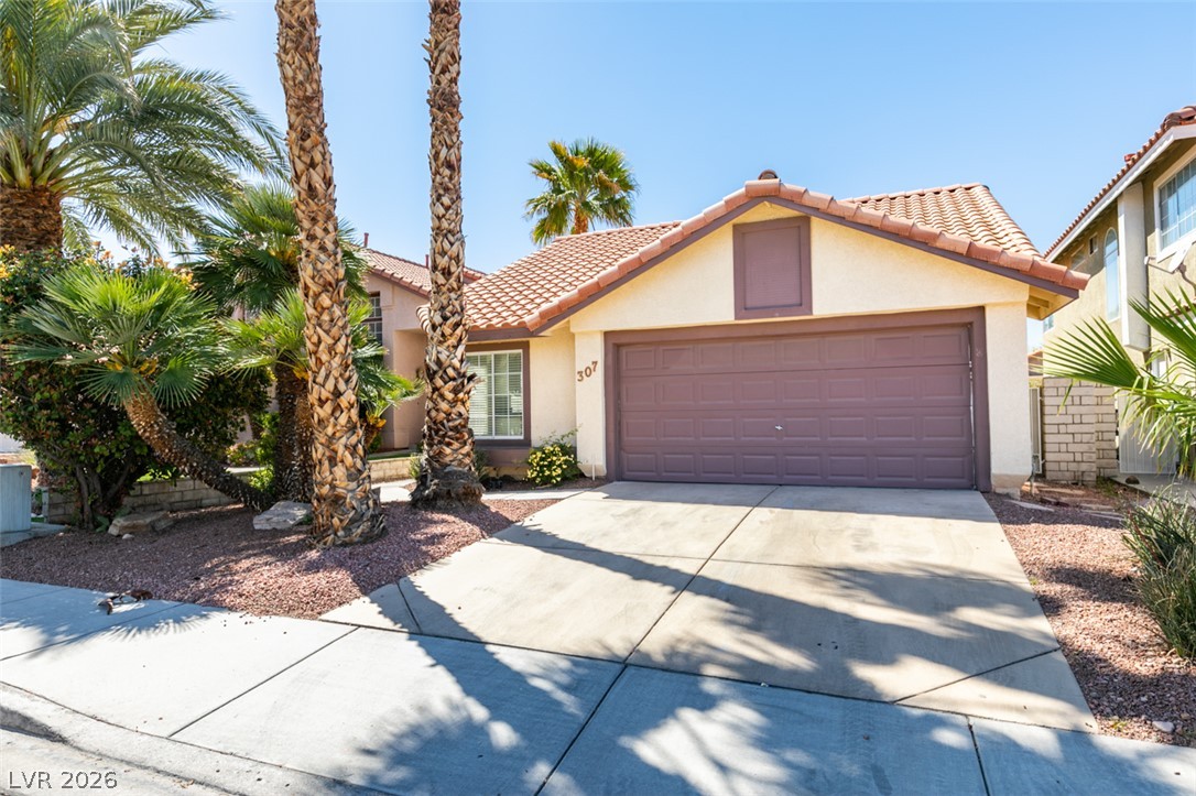 307 Cavalla Street Henderson, NV 89074 - Photo 2 of 44 Mature palm trees adorn the front of this inviting stucco home with a tile roof.