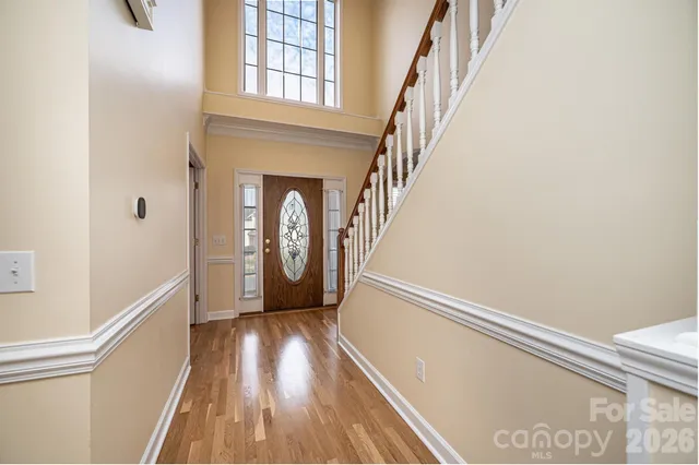 a view of hallway with stairs and wooden floor