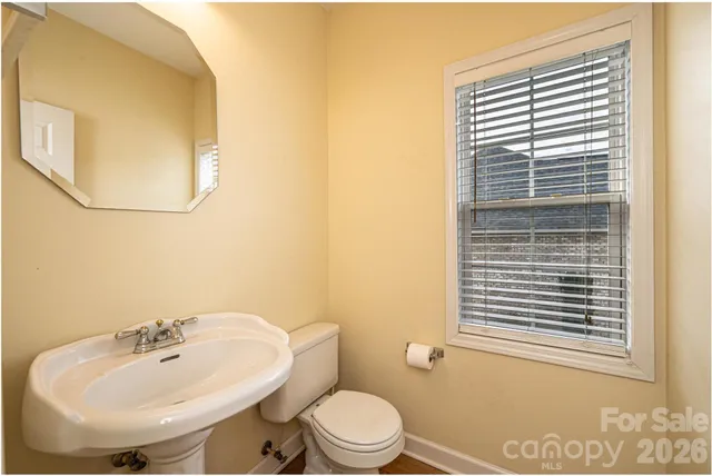 a bathroom with a sink a mirror and a toilet