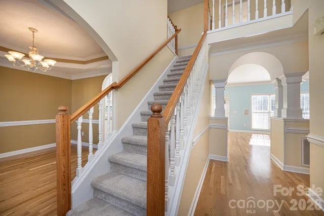 a view of entryway and hall with wooden floor