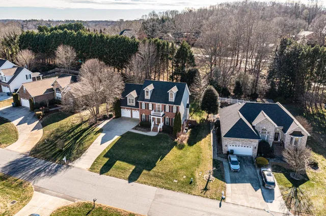 a view of a house with backyard and patio
