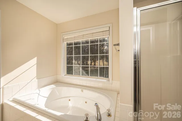a bathroom with a bathtub and a window
